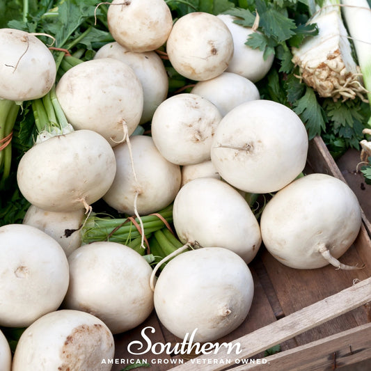 White beets in a wooden crate with green leaves, featuring 'Southern' brand text.