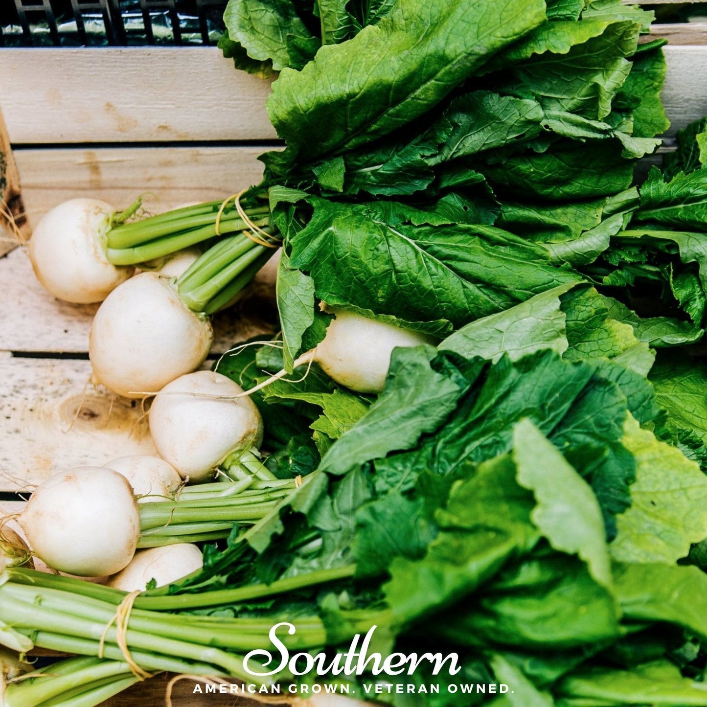 White beets with green tops on a wooden surface with 'Southern' branding.