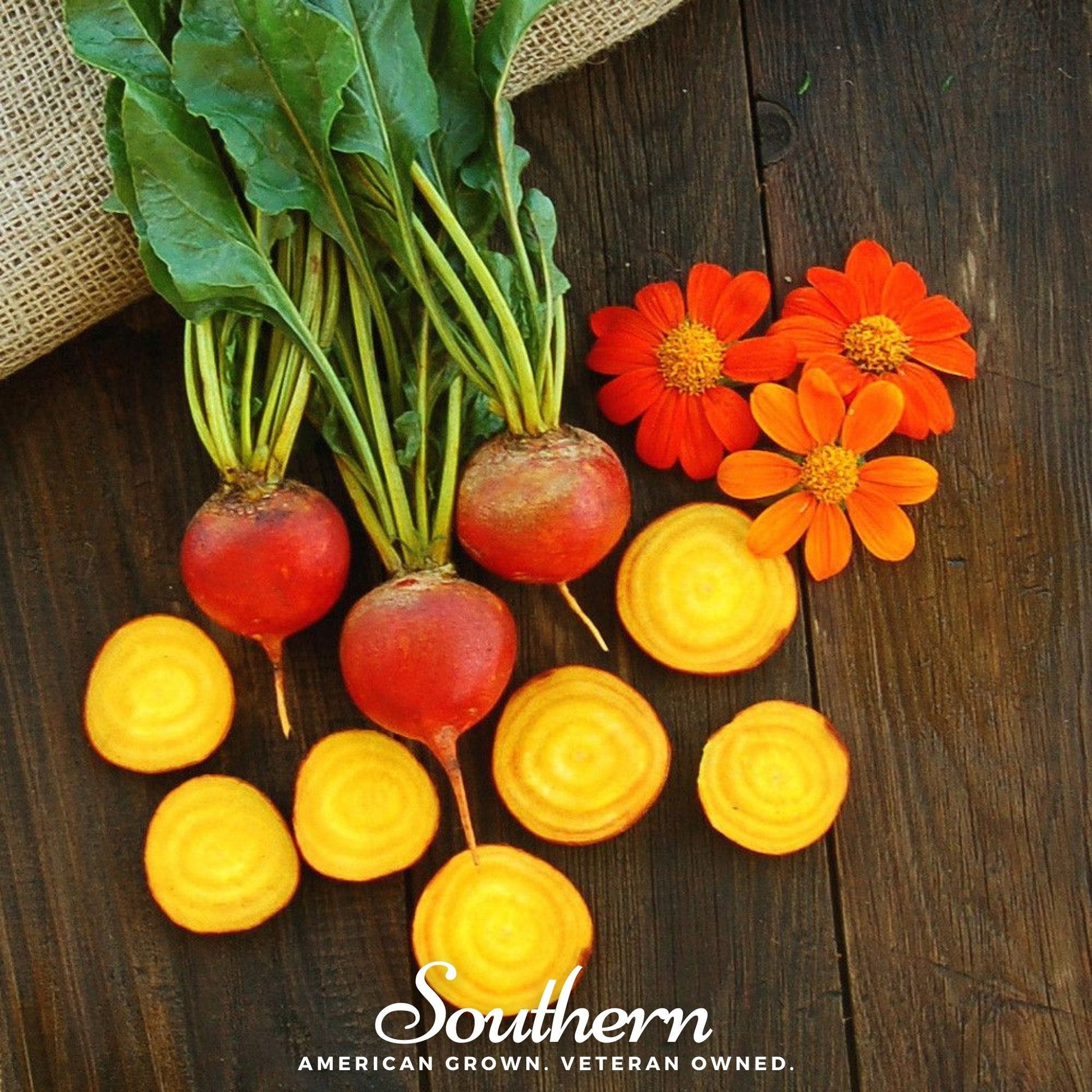 Bunch of beets with sliced rounds and orange flowers on a wooden surface, featuring 'Southern' brand.