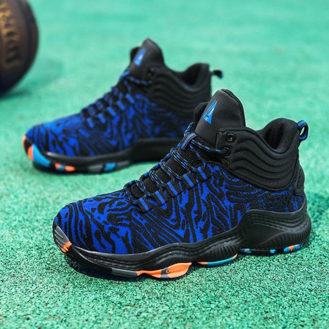 Blue and black patterned sneakers on a green surface
