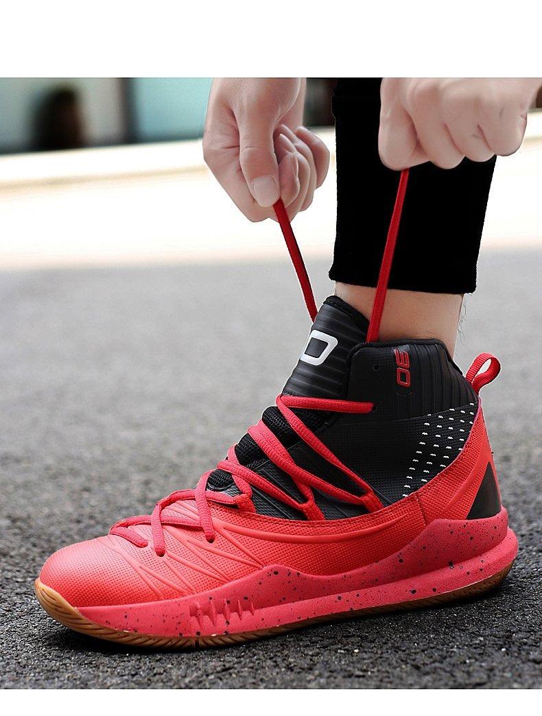 Person tying red and black athletic shoes on a blurred background