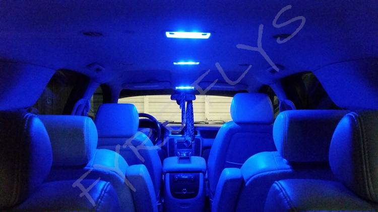 Car interior with blue LED lights illuminating the dashboard and seats.