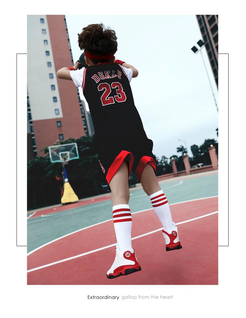 Person wearing a basketball jersey with number 23 on an outdoor court.