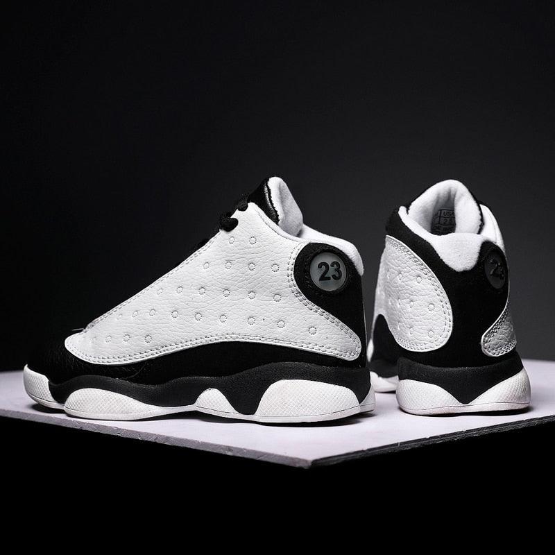 Black and white sneakers with '23' logo on a dark background