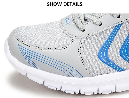 Gray athletic shoe with blue accents on a white background