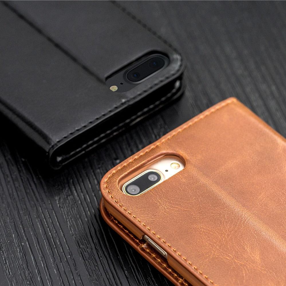 Black and brown phone cases on a dark wooden surface