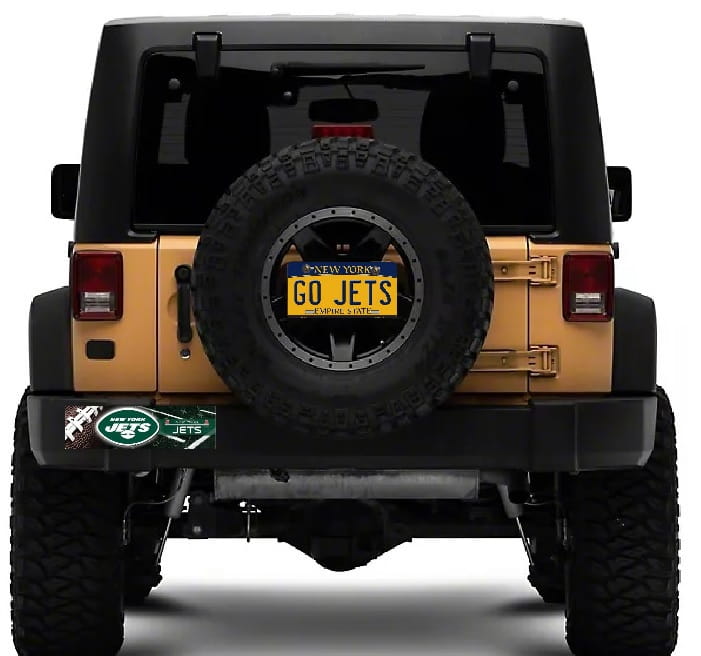 Jeep with a spare tire and 'GO JETS' license plate on a white background
