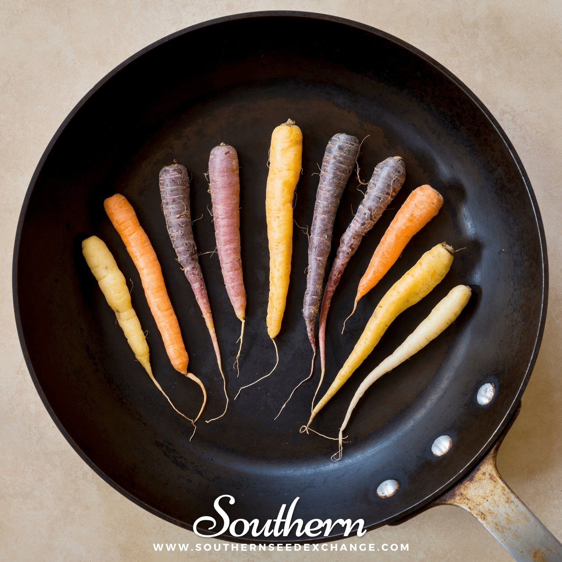Multicolored carrots on a black frying pan with 'Southern' branding.