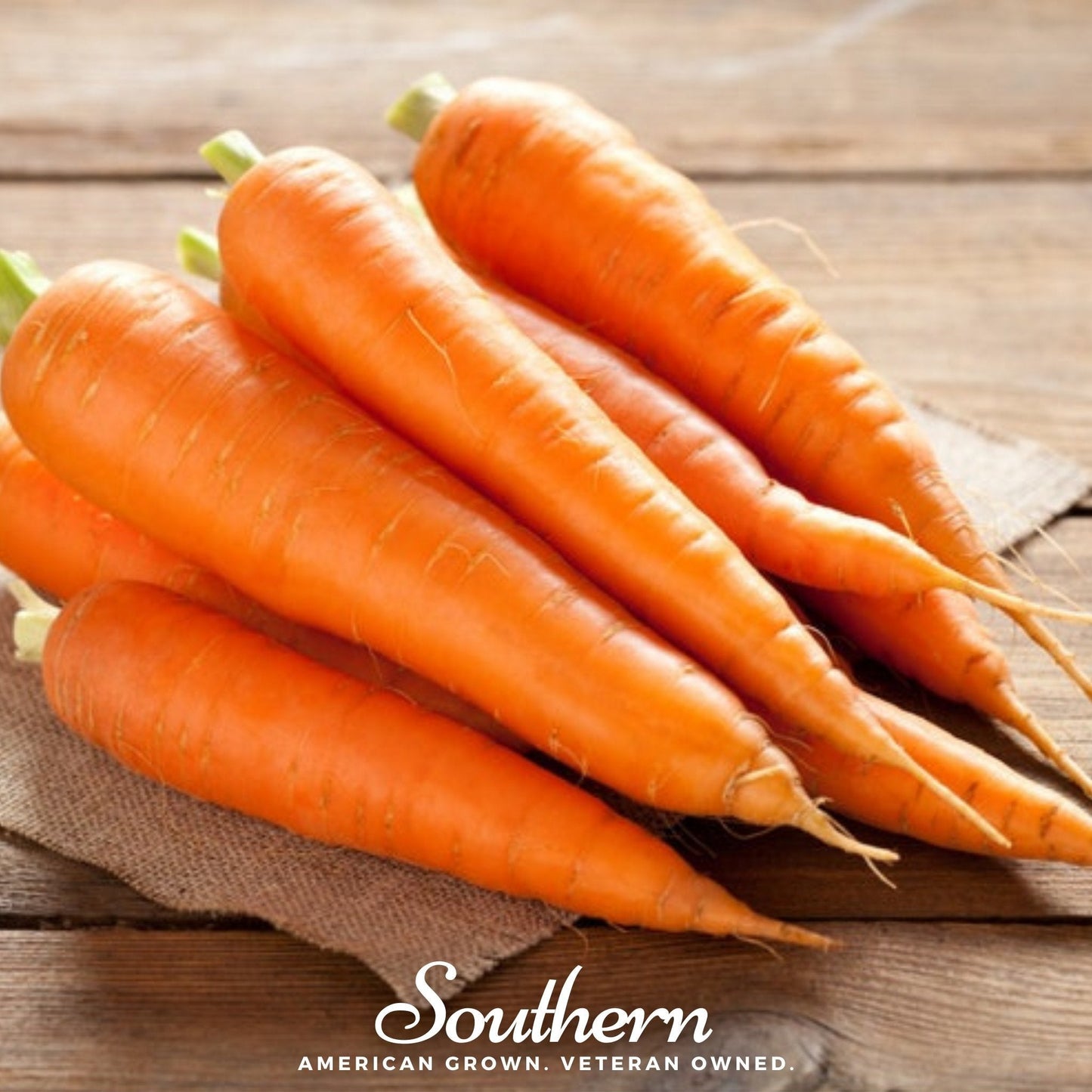 Bunch of carrots on a wooden surface with 'Southern' branding.