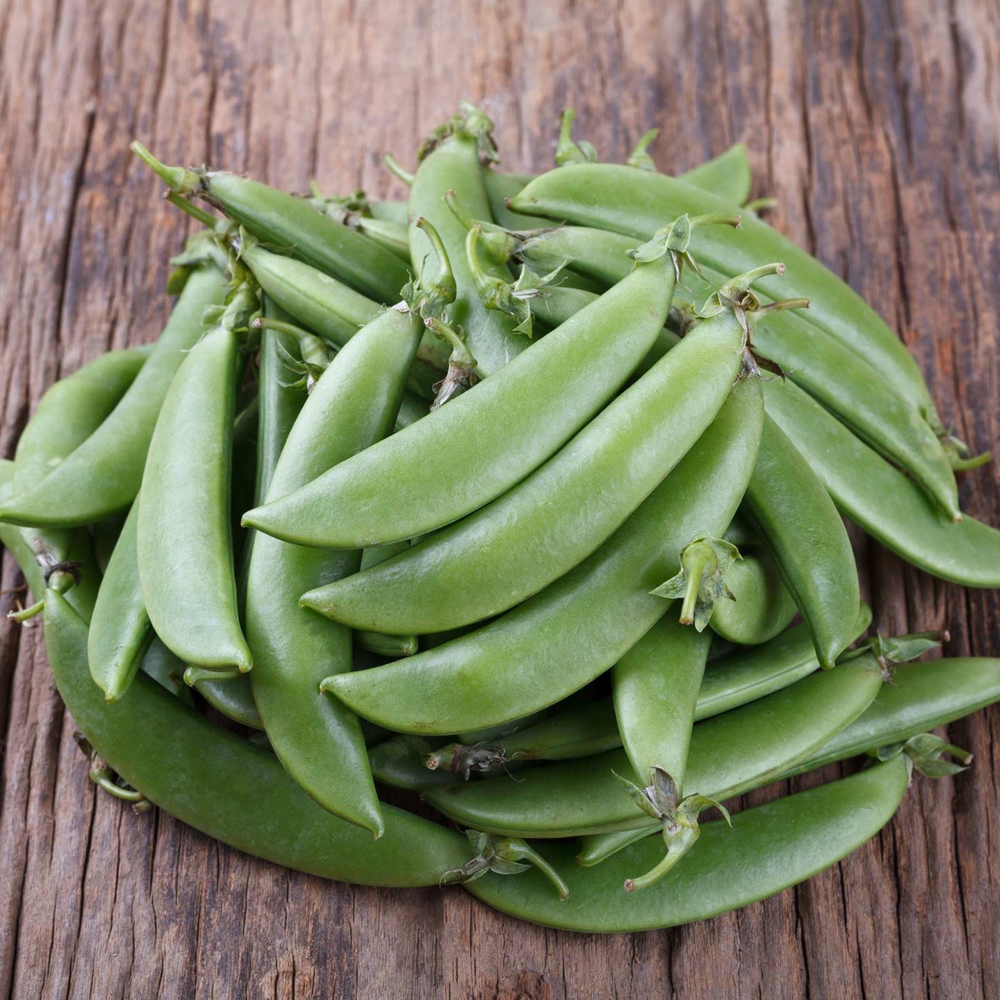 Sugar Snap peas on a wooden surface