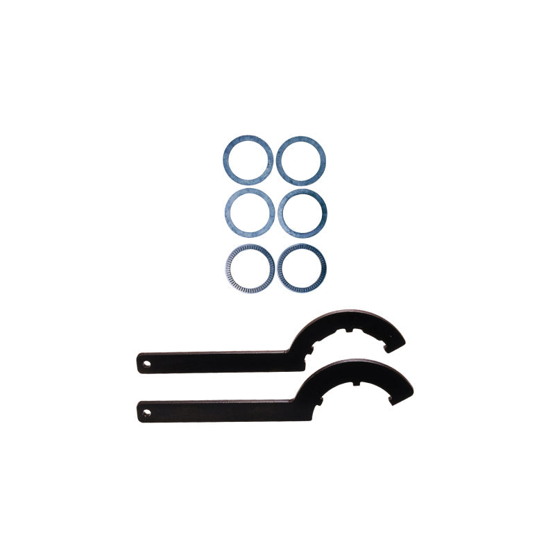 Two black metal brackets and six blue washers on a white background
