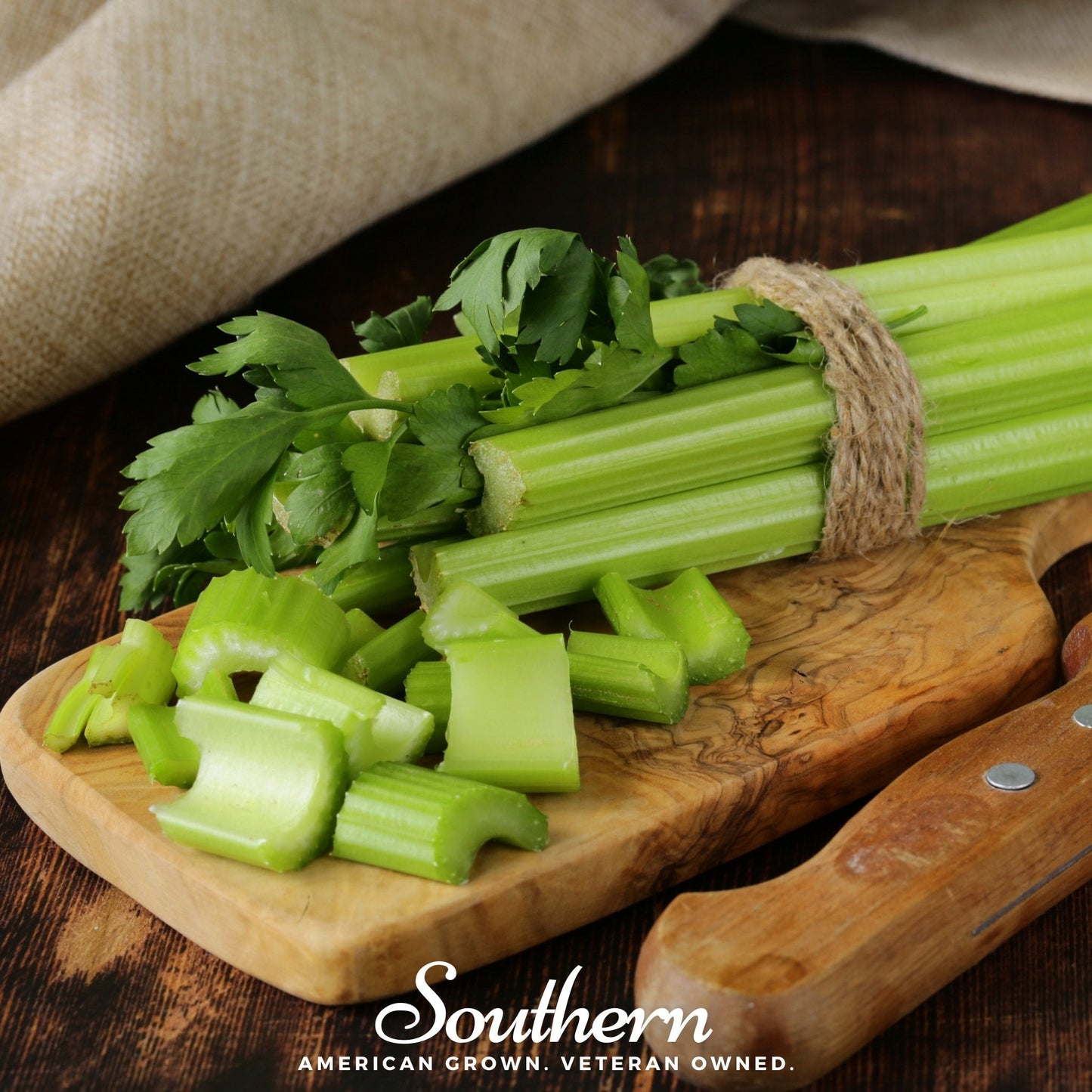 Bunch of celery with some chopped pieces on a wooden cutting board, branded 'Southern'.