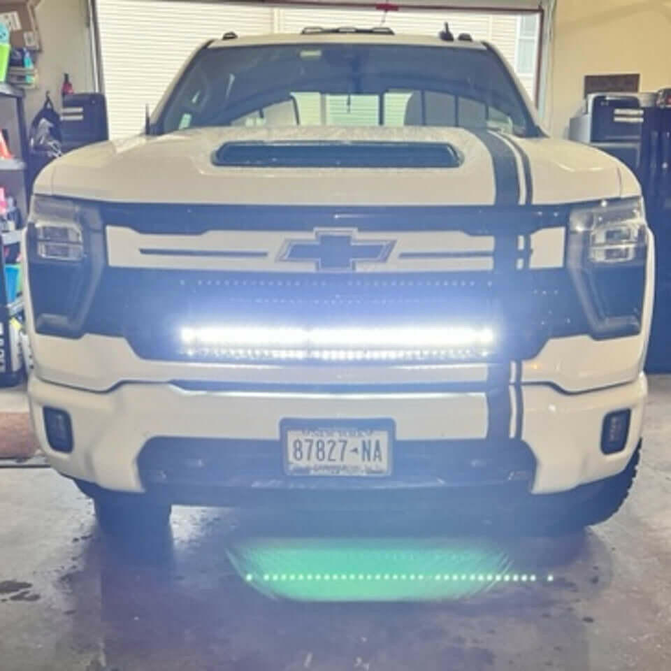 White Chevrolet truck with LED lights in a garage