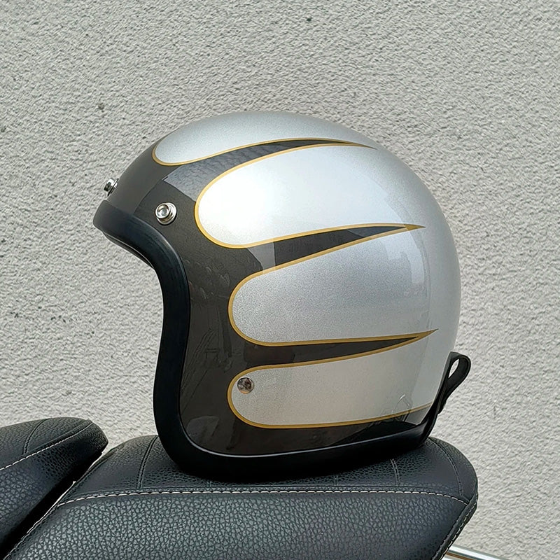 Motorcycle helmet with black and gold design on a textured wall background