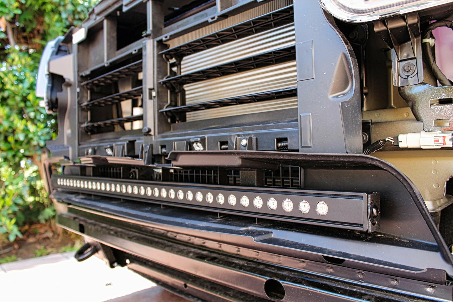 Close-up of a vehicle's front bumper with LED light bar