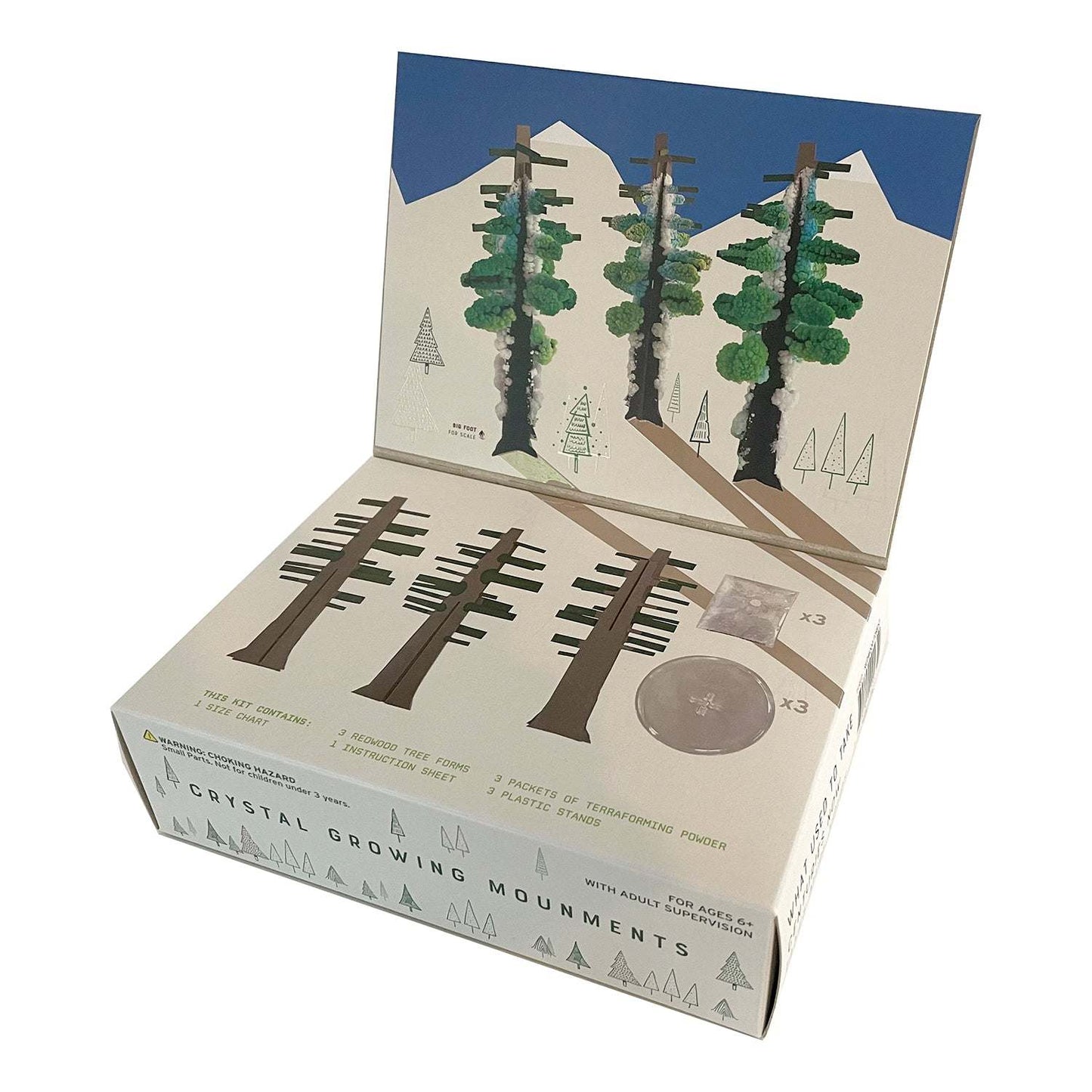 Box of crystal growing monuments with tree design on a white background