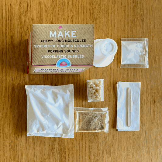 Bubble Gum Chemistry Kit components on a wooden surface