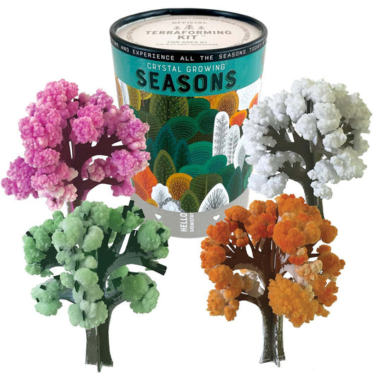Crystal growing kit with trees in different colors and a container labeled 'Crystal Growing Seasons'.
