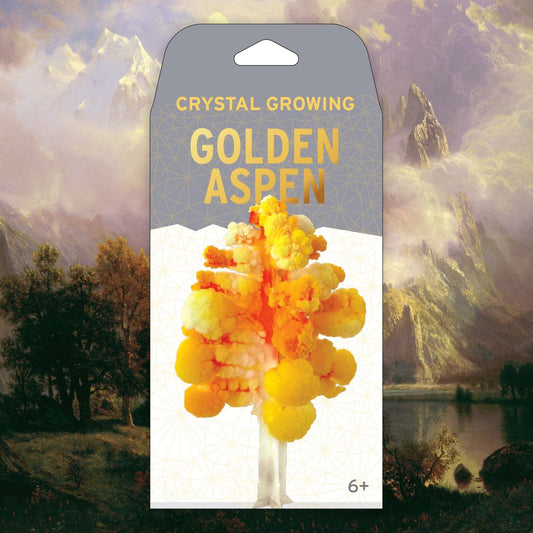 Crystal growing kit packaging for 'Golden Aspen' with a scenic background