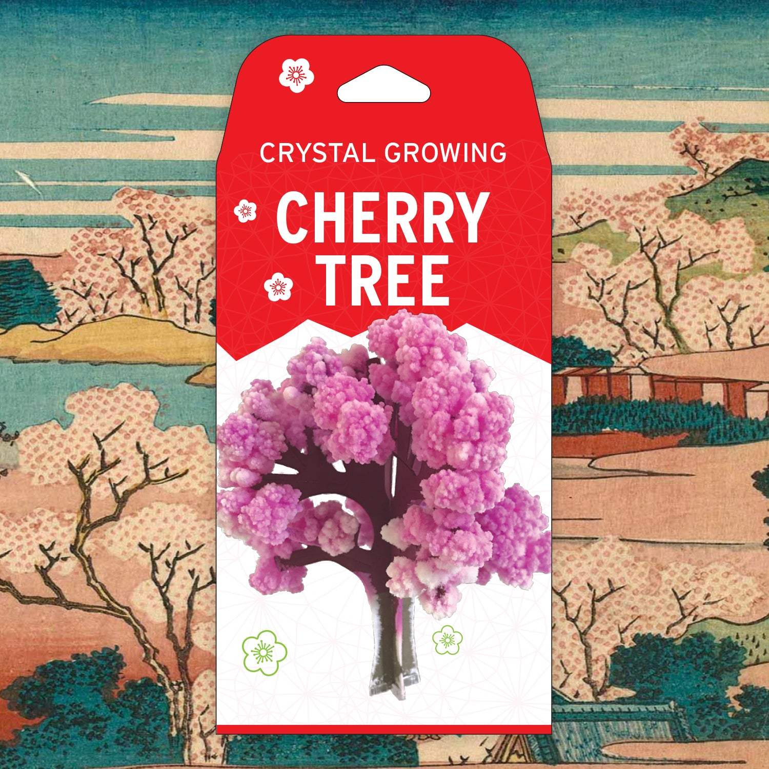 Crystal growing cherry tree packaging with a red label on a traditional Japanese landscape background.