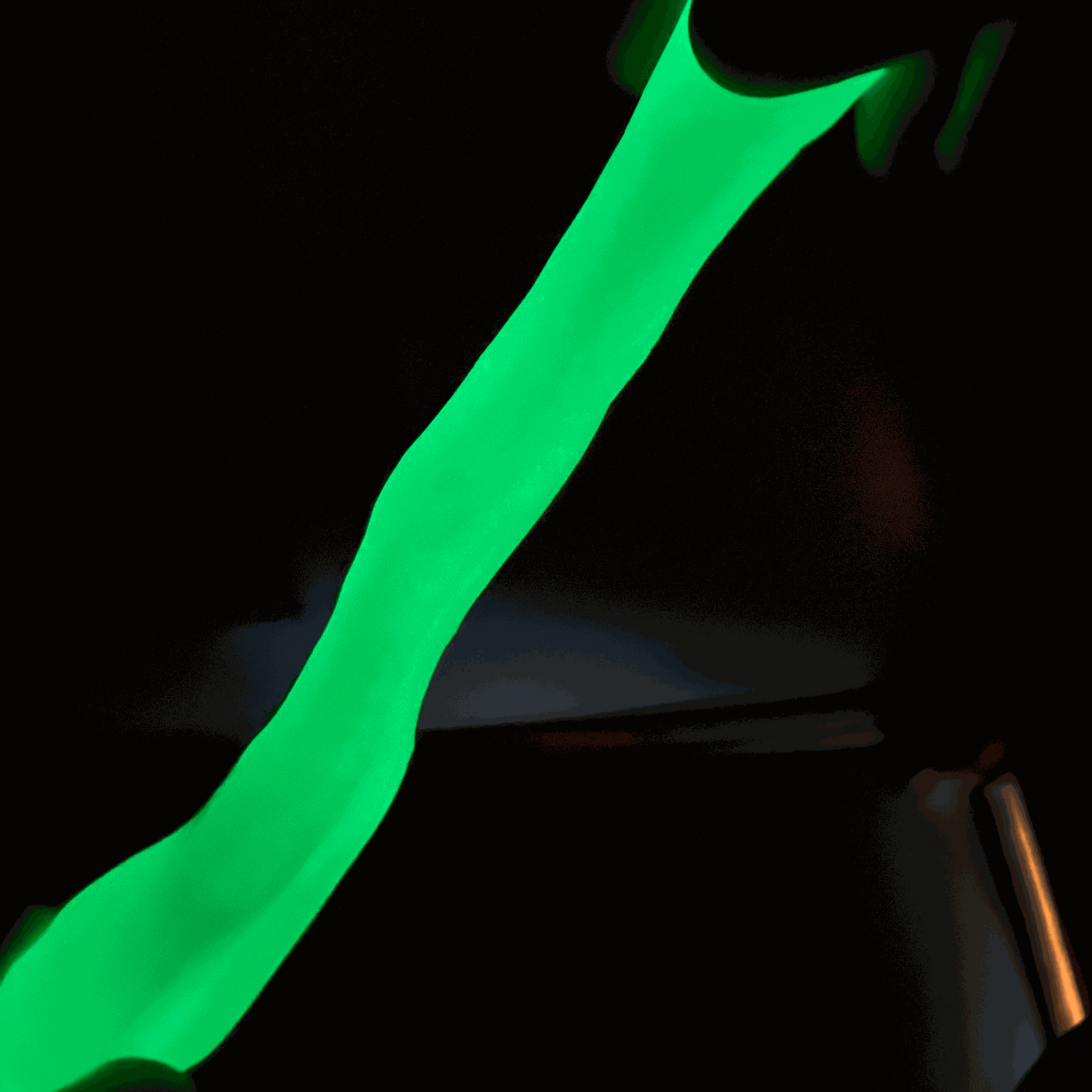Glowing green gootonium stretched in the dark