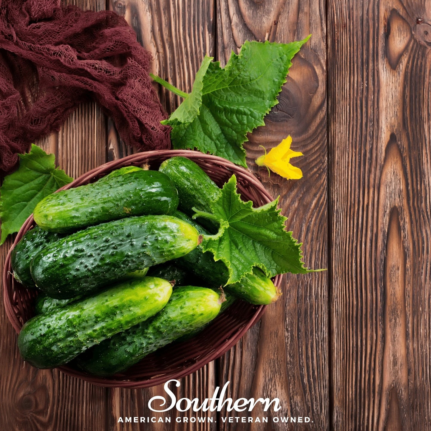 Bowl of cucumbers with leaves on a wooden surface, featuring the 'Southern' brand.