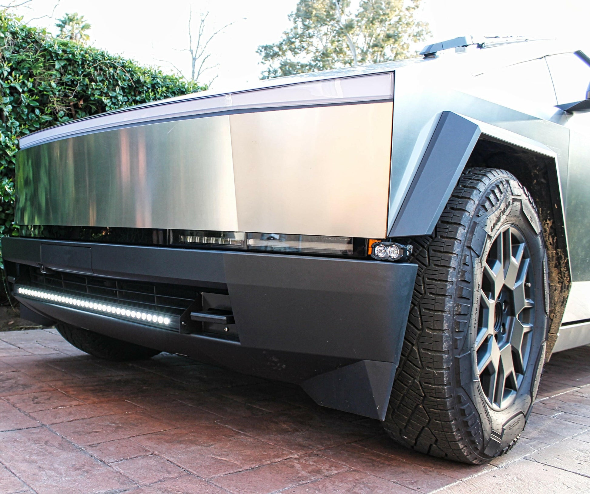 Modern electric vehicle with a sleek design on a driveway with LED Light Bar mounted on it.