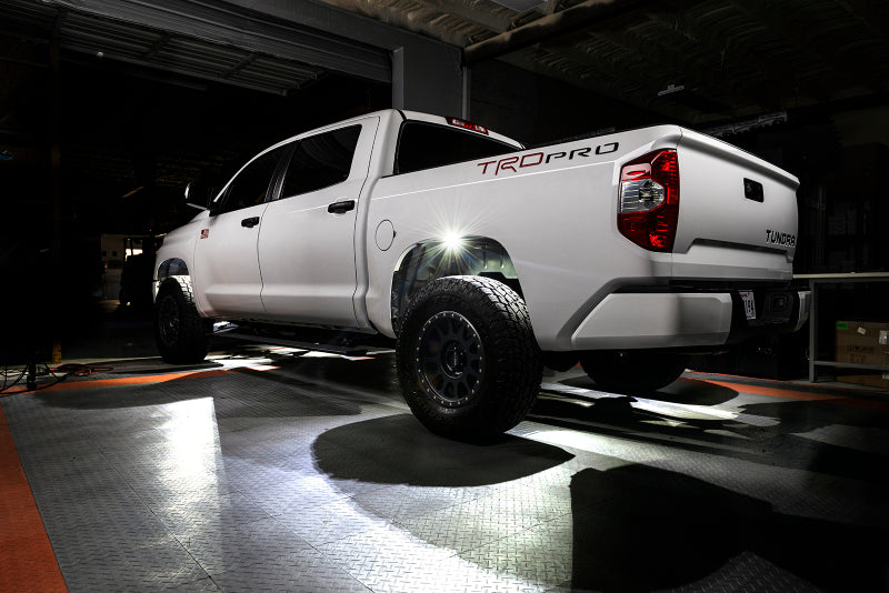 White truck with 'Trop Pro' branding in a dark indoor setting