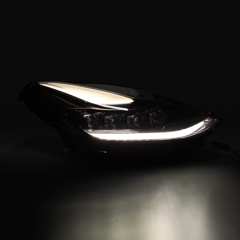 Car headlight with LED daytime running light on a dark background