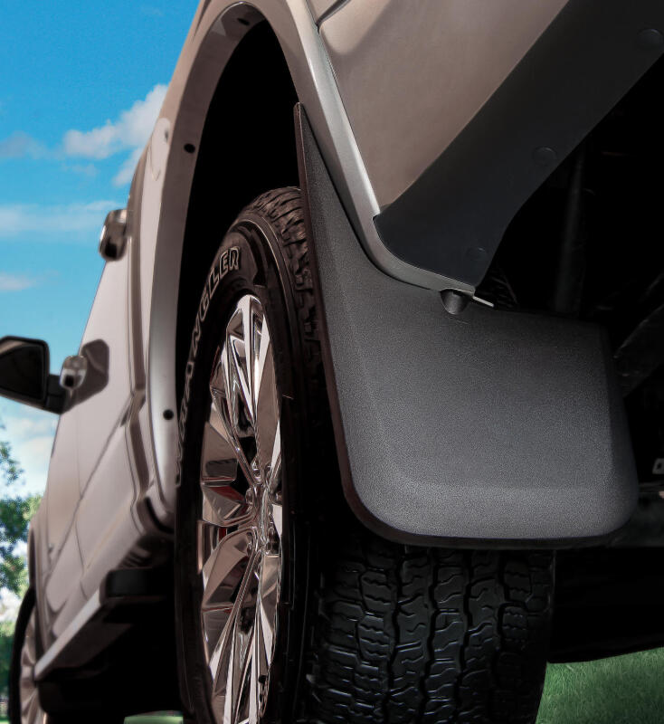 Close-up of a vehicle's wheel and fender with a clear sky background