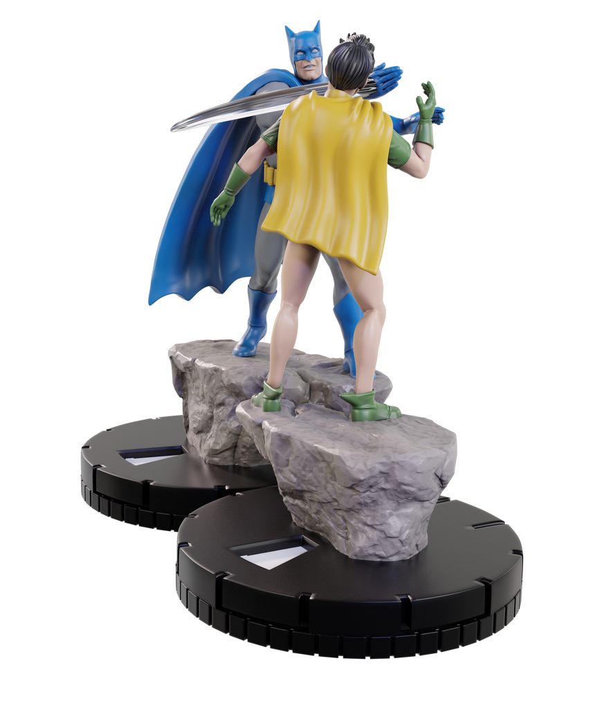 Statue of a superhero in a yellow cape and blue mask on a rock platform with another figure in green gloves and boots.