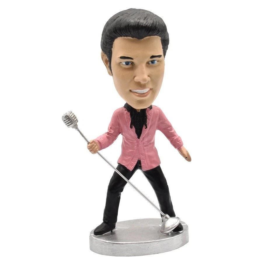 Bobblehead figure of Elvis in a pink jacket holding a microphone on a white background
