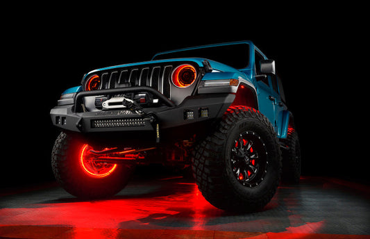 Blue off-road vehicle with glowing red wheels on a dark background