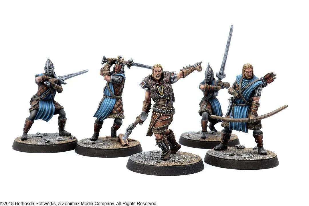 Five painted miniature figures of fantasy warriors on a white background