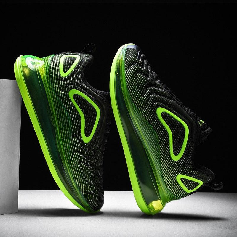 Black and green athletic shoes on a black background