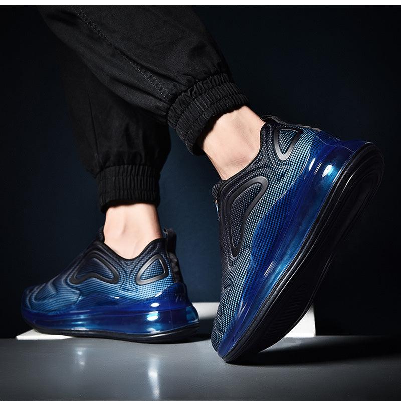 Blue and black athletic shoes worn by a person on a dark background
