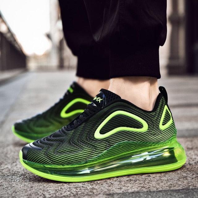 Green and black athletic shoes on a blurred street background
