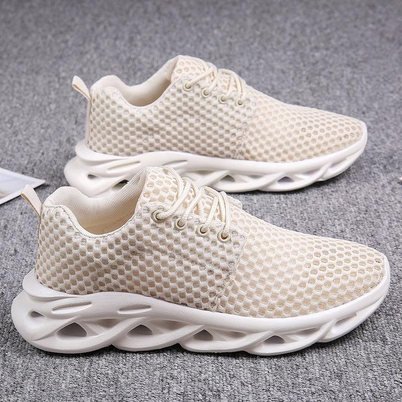 Beige running shoes with white soles on a gray background