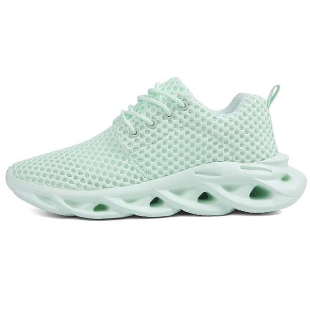 Light green sneaker with unique sole design on a white background