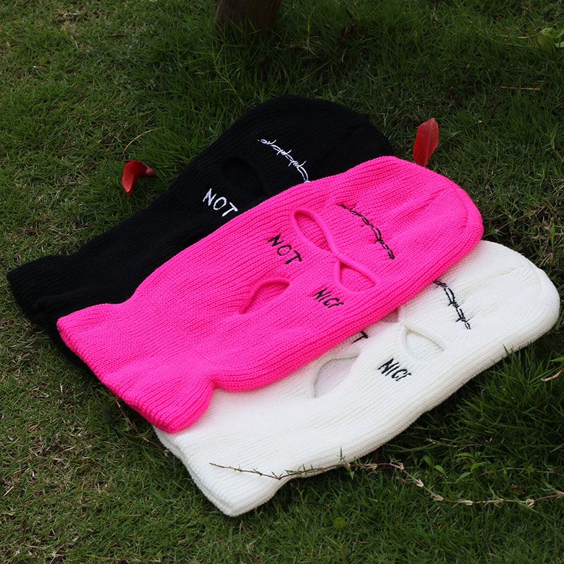 balaclava / Face masks  with 'NOT' text on a white and black background on grass