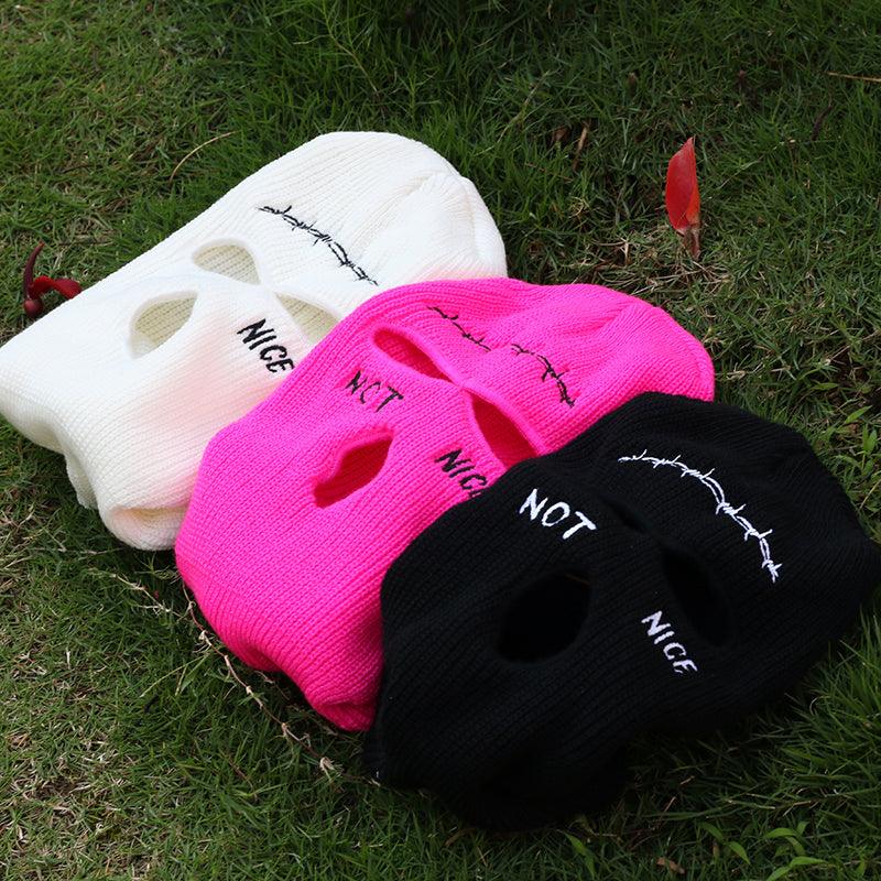 balaclava / Face masks  in white, pink, and black on grass with text 'NICE' and 'NOT'.