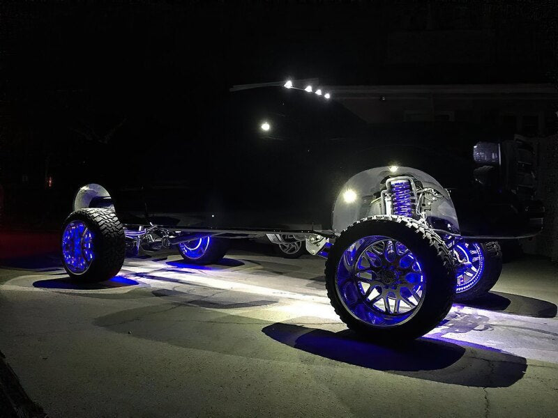 Black off-road vehicle with underbody lighting on a dark background