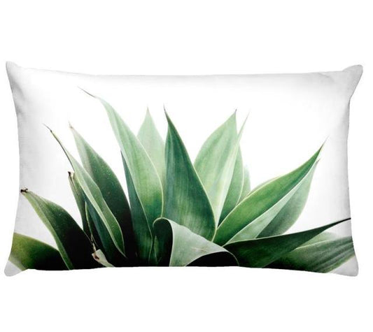 Decorative pillow with a green plant design on a white background