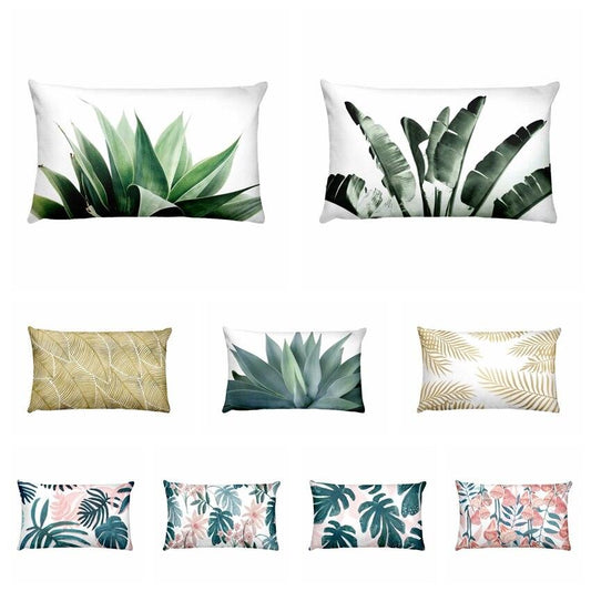 Collection of tropical leaf patterned pillows on a white background