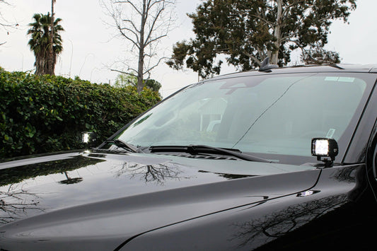 Car hood with a small light on a clear day