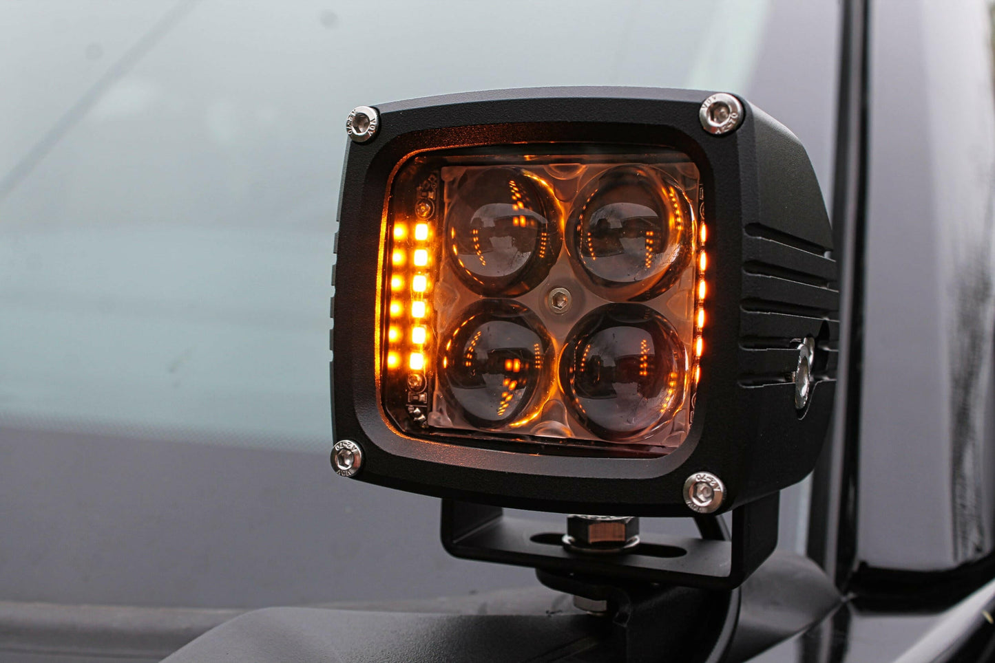 Square amber LED light on a vehicle with a blurred background