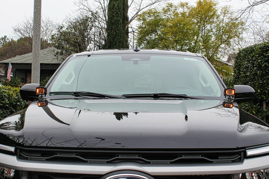 Front view of a black truck with a blurred background