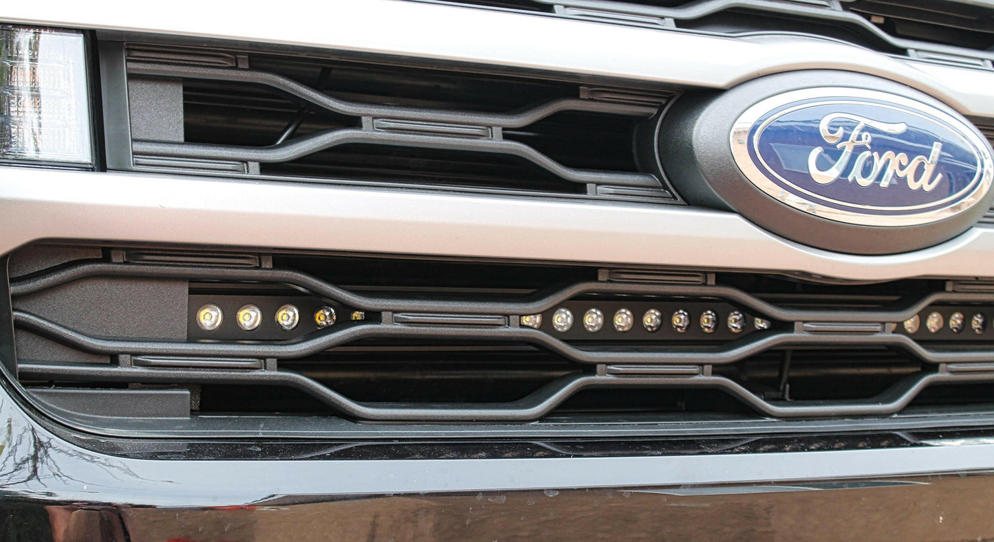 Close-up of a Ford vehicle grille with logo above LED light Bar