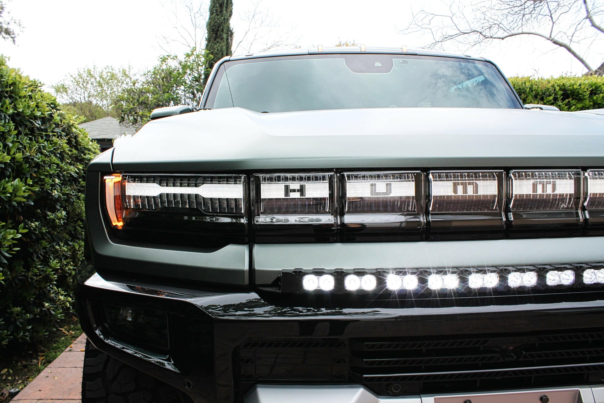 Front view of a hummer truck with large grille and LED lights