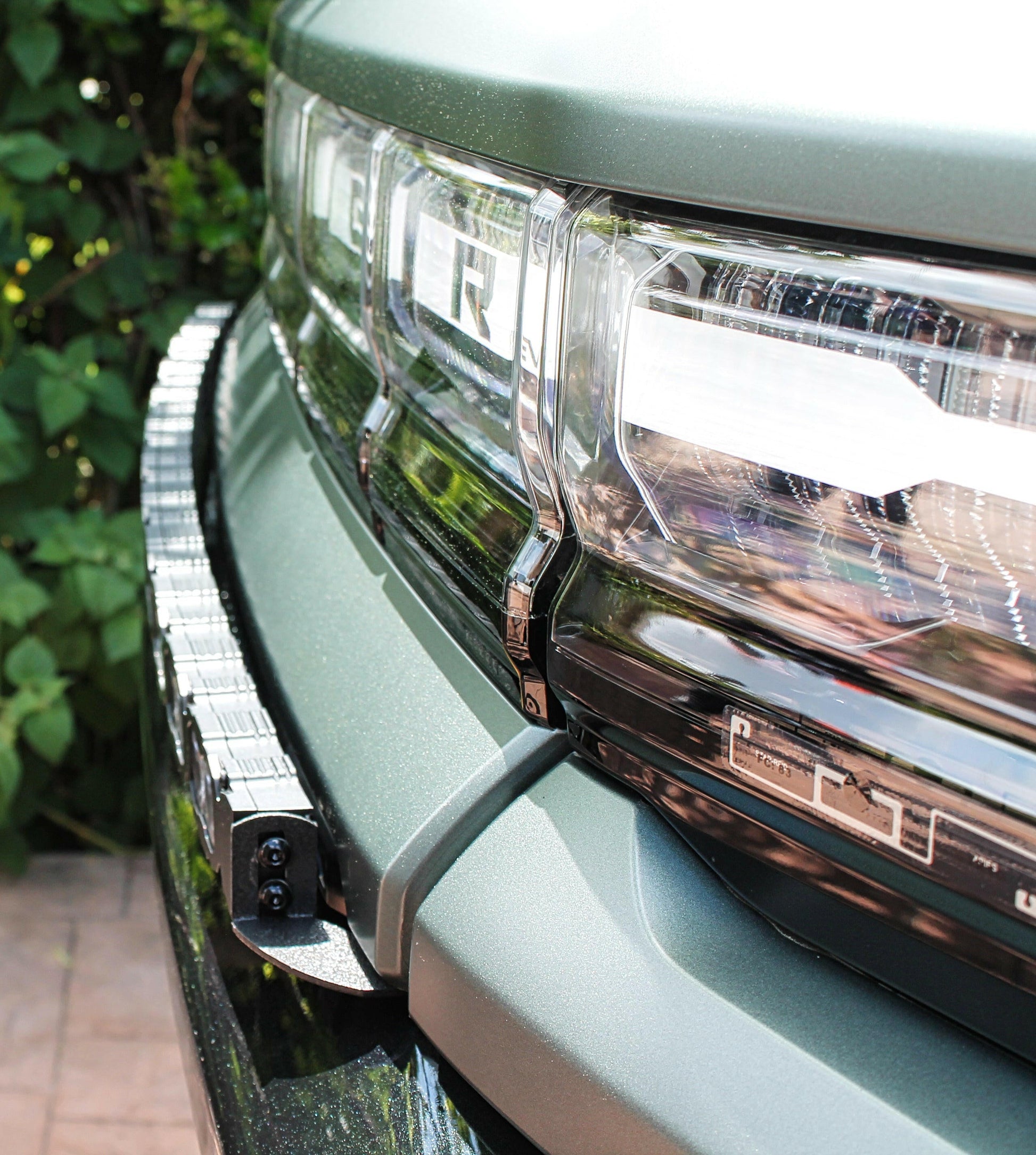 Close-up of a vehicle's front grille with additional lighting equipment.